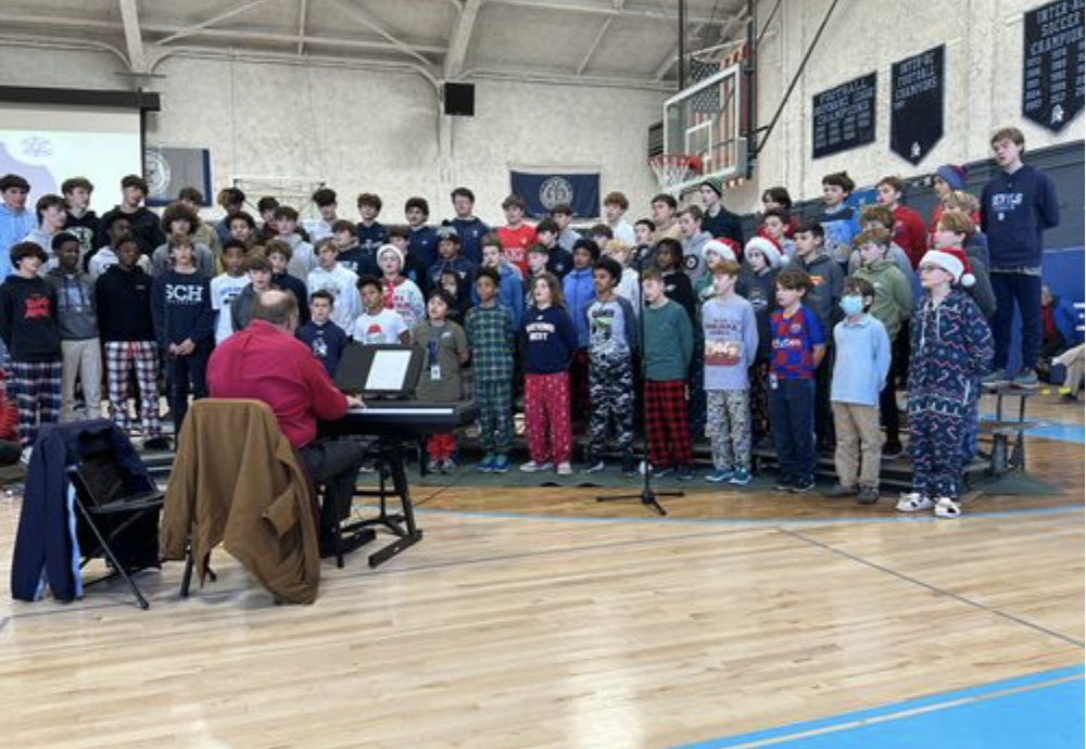 The Middle School boy choir sings during assembly.